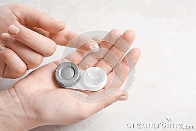 Woman holding contact lens and cas Stock Photo