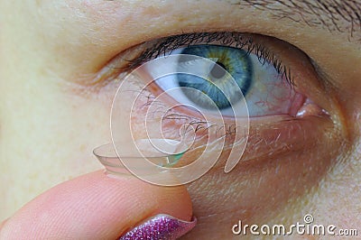 Woman eye with contact lens Stock Photo