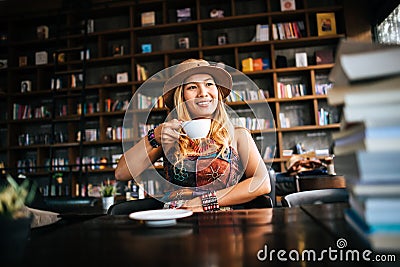 Woman is holding a cup of hot cappuccino and reading a book, Business woman read a book Stock Photo