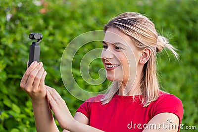 Woman holding DJI Osmo Camera Stock Photo