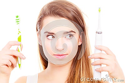 Woman holding electric and traditional toothbrush Stock Photo