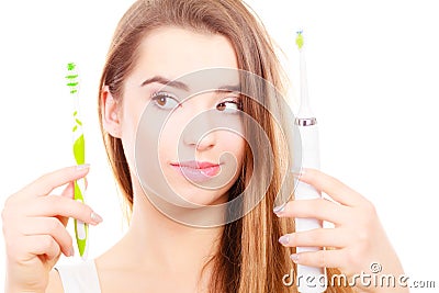Woman holding electric and traditional toothbrush Stock Photo