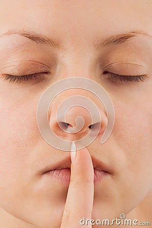 Woman holding finger to lips Stock Photo