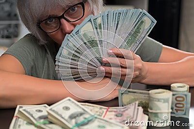 Woman holding a fistful of 100 dollar bills Stock Photo