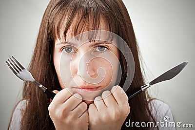 Woman holding fork and knife Stock Photo