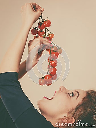 Woman holding fresh cherry tomatoes Stock Photo