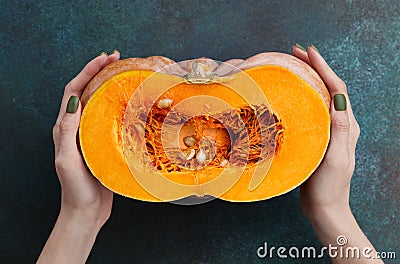 Woman holding fresh half of pumpkin Stock Photo