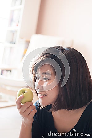 Woman holding green apple with happy smiling. Stock Photo