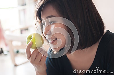 Woman holding green apple with happy smiling. Stock Photo