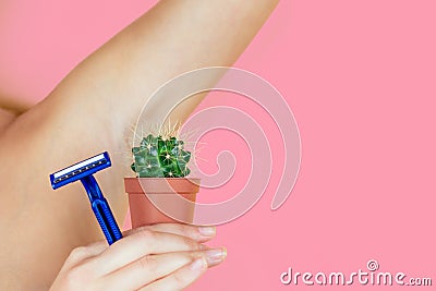 A woman holding a green cactus in a brown pot and a razor near the armpits. the concept of depilation, hair removal and Stock Photo