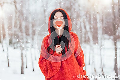 Woman holding in hand red heart for Valentines Day on winter background Stock Photo