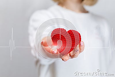 A woman is holding a heart in her hand Stock Photo