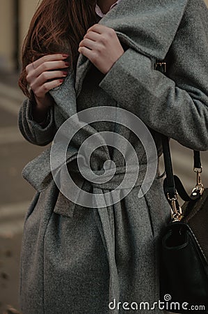 Woman holding her autumn coat closeup Stock Photo