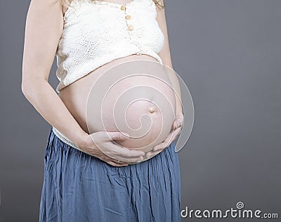 Woman holding her baby bump Stock Photo