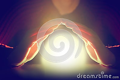 Woman holding her hands over glowing sphere of light. Protection, future. Stock Photo