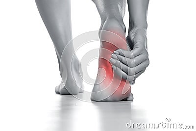 woman holding her painful foot on white Stock Photo