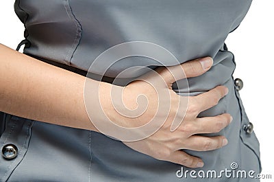 Woman holding her stomach with pain on hemorrhoids Stock Photo