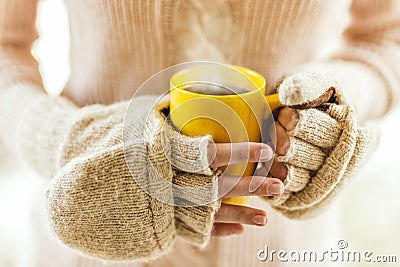 Woman holding hot steaming coffee cup close up photo Stock Photo