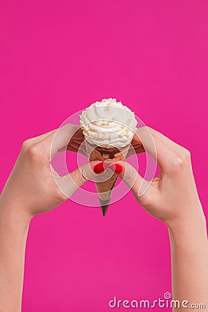 Female hand holding ice cream in waffle cone Stock Photo