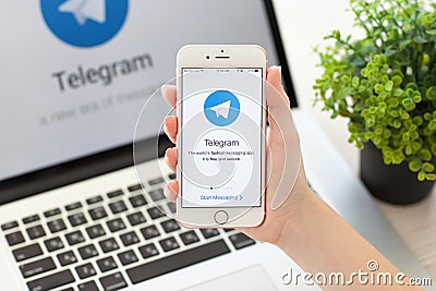 Woman holding iPhone 6S Rose Gold with social service Telegram Editorial Stock Photo