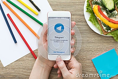 Woman holding iPhone with social networking service Telegram on Editorial Stock Photo