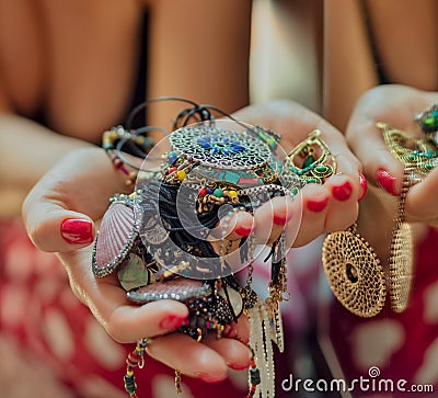 Woman holding jewelry in front of the mirror Stock Photo