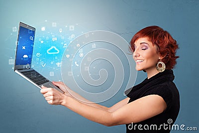 Woman holding laptop with cloud based system notifications Stock Photo