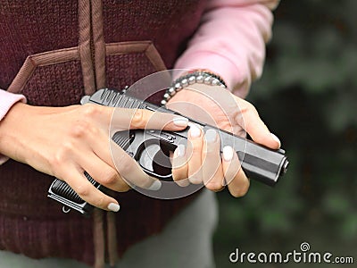 Woman holding a loaded gun Stock Photo