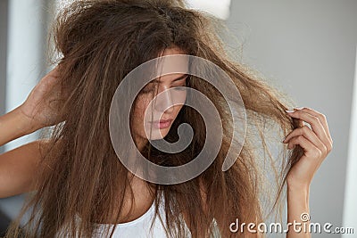 Woman With Holding Long Damaged Dry Hair. Hair Damage, Haircare. Stock Photo