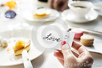 Woman holding love note on small card Stock Photo