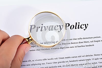 Woman Holding Magnifying Glass Over Privacy Policy Form Stock Photo
