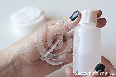 Woman is holding a nail polish remover. Stock Photo