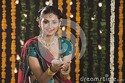 Woman holding an oil lamp on Diwali Stock Photo