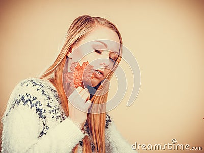 Woman holding orange autumn leaf Stock Photo