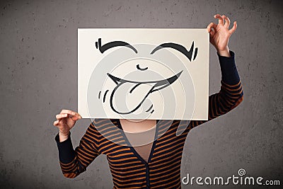 Woman holding a paper with cute smiley face on it in front of he Stock Photo