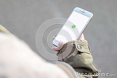 16. November 2019, SchwÃ¤bisch GmÃ¼nd, Germany: Woman holding a phone in the hands. WhatsApp logo on the cellphone screen Editorial Stock Photo