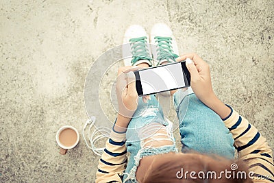 Woman holding phone white screen on top view vintage style Stock Photo