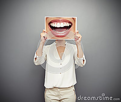 Woman holding picture with big smile Stock Photo