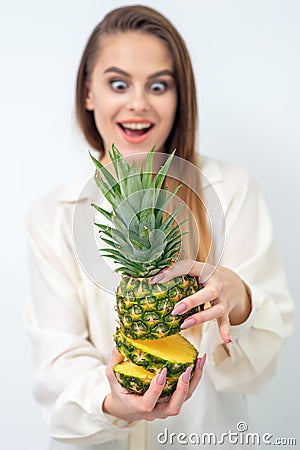 Woman holding pineapple in section Stock Photo