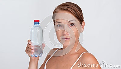 Woman holding plastic bottle of water on white background Stock Photo