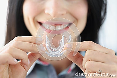 Woman holding plastic mouth guard for bruxism treatment closeup Stock Photo