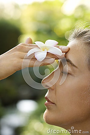 Woman holding plumeria flower. Stock Photo