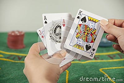 Young woman holding poker cards Stock Photo