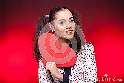 Woman holding a red papper heart in hands Stock Photo