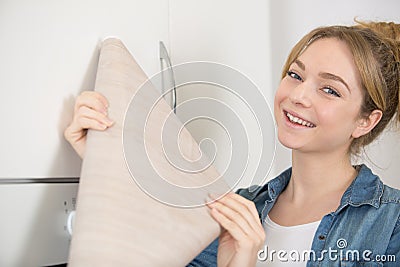 woman holding roll veneer to revamp kitchen cupboards Stock Photo