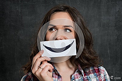 Woman Holding Smiley Emoticon Stock Photo