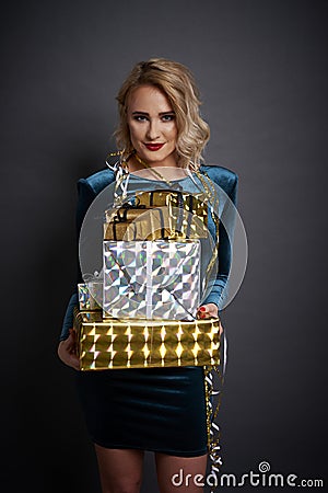 Woman holding a stack of gifts Stock Photo