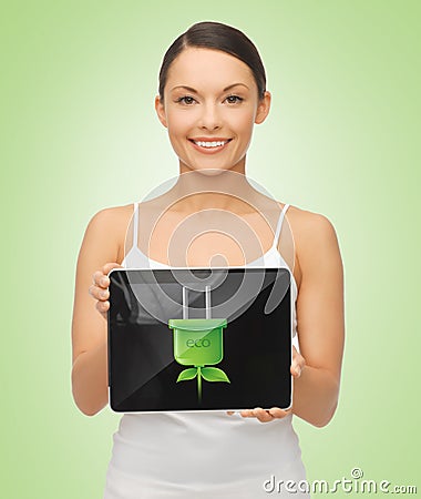Woman holding tablet pc with green electrical plug Stock Photo