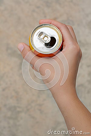 Woman holding tasty open canned beverage against blurred background, top view Stock Photo