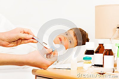 Woman holding thermometer and checking temperature Stock Photo